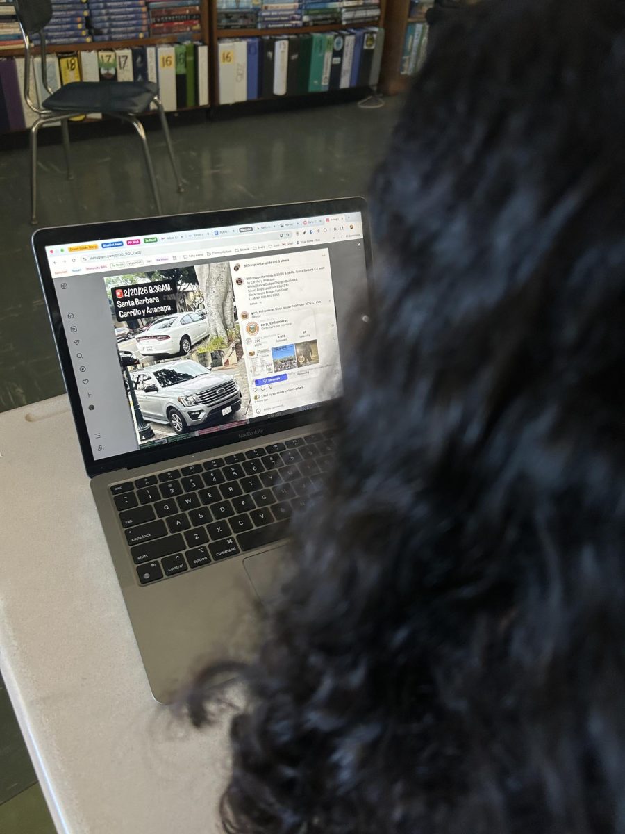 A student looks for updates on
805 Rapid Response Network's instagram. Photo by Ethan Maday
