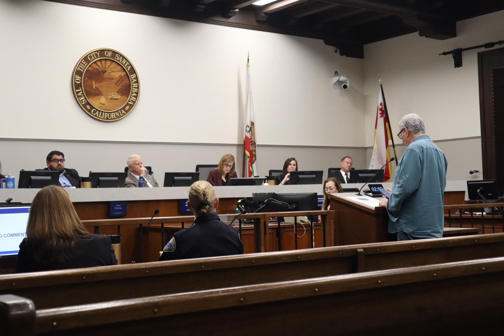 A constituent gives public comment before the city council. In this photo: Councilmember Oscar Gutteriez, Mayor Randy Rowse, Councilmembers Kristen Sneddon, Megan Harmon, and Mike Jordan. Photo by Ethan Maday